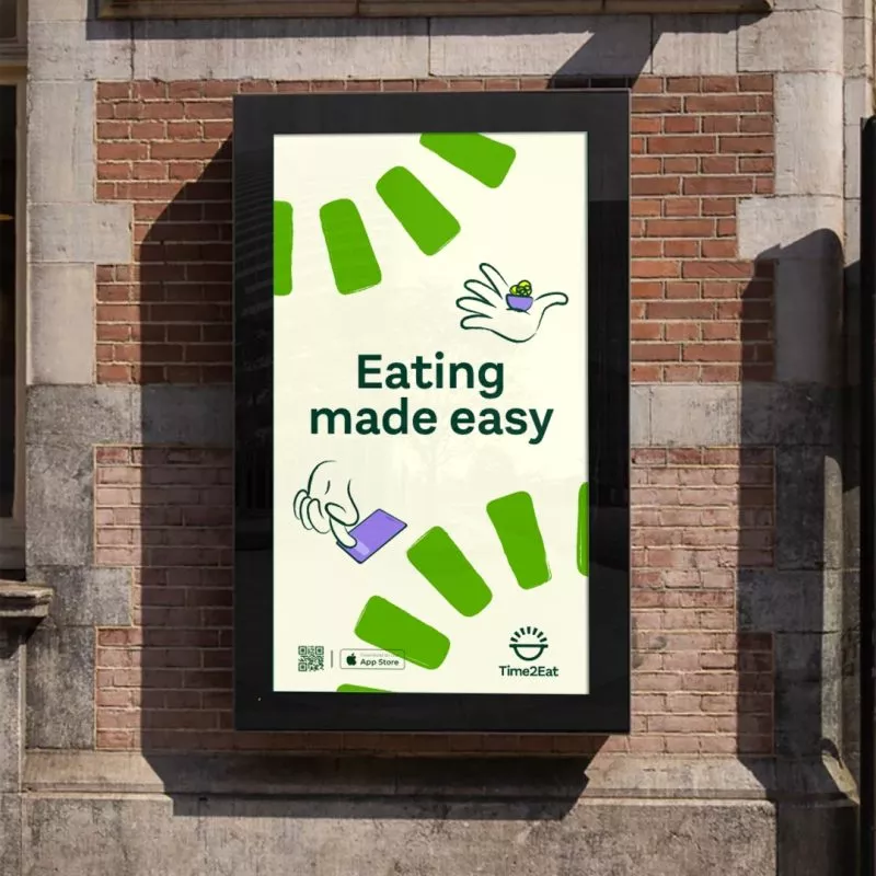 Time to Eat branded poster on outside of brick building saying 
